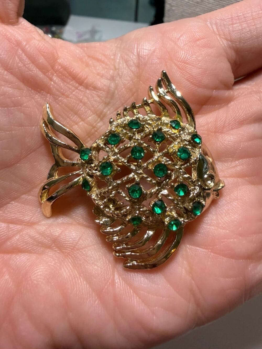 Vintage gold tone and faux emerald fish brooch 1.5”